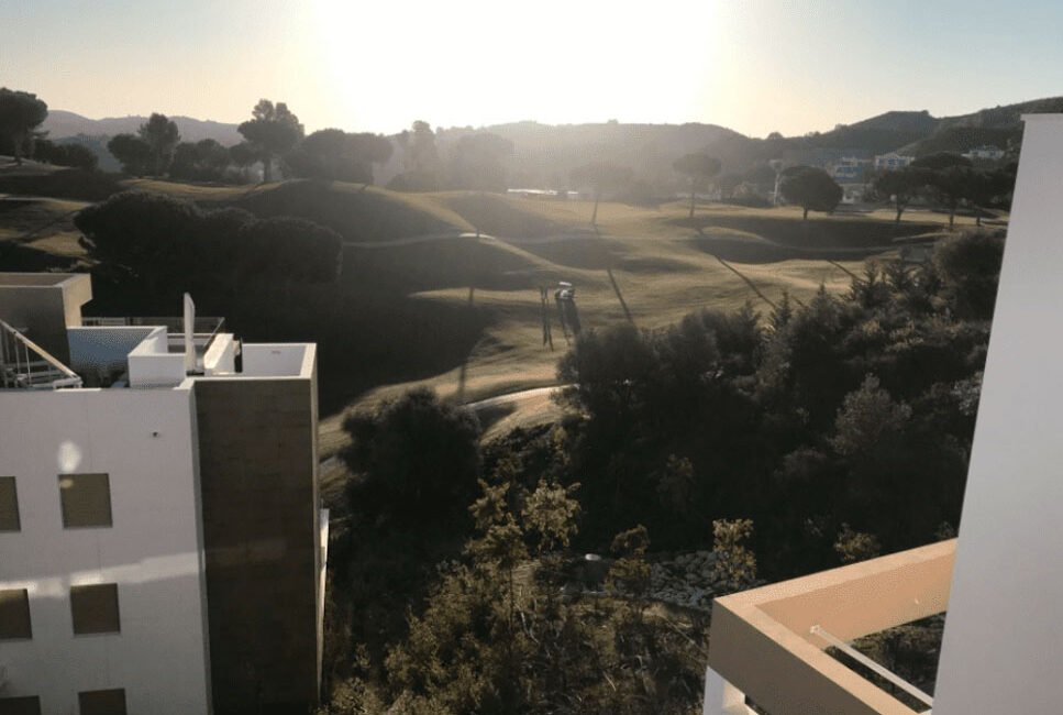A chartered surveyor undertaking snagging report of an apartment in Mijas, Spain, that has a golf course view.