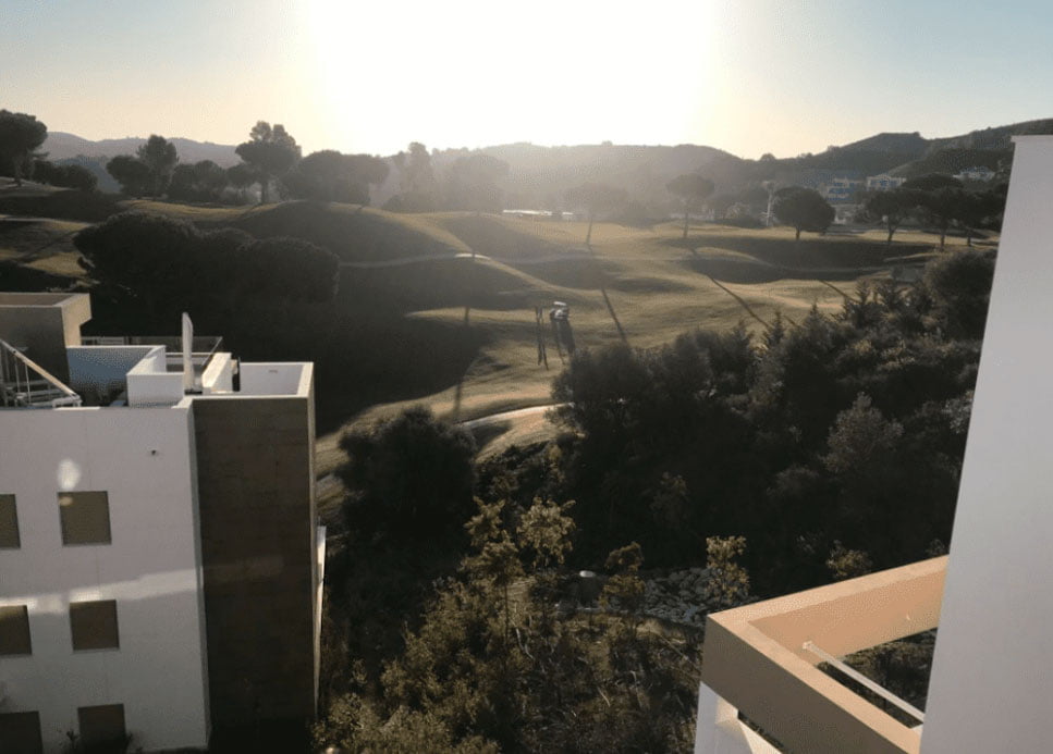 A chartered surveyor undertaking snagging report of an apartment in Mijas, Spain, that has a golf course view.